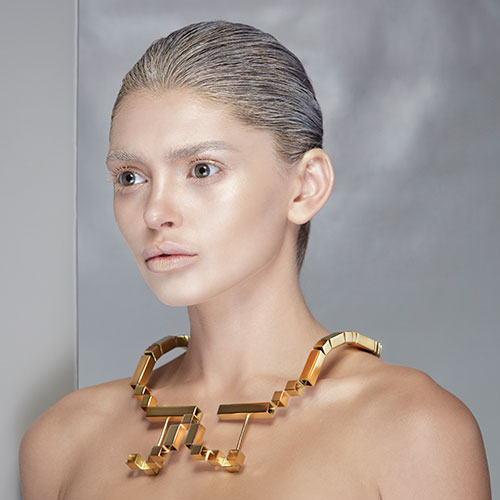 woman wearing a gold necklace