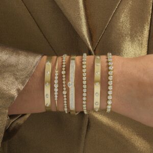 hand full of gold bracelets
